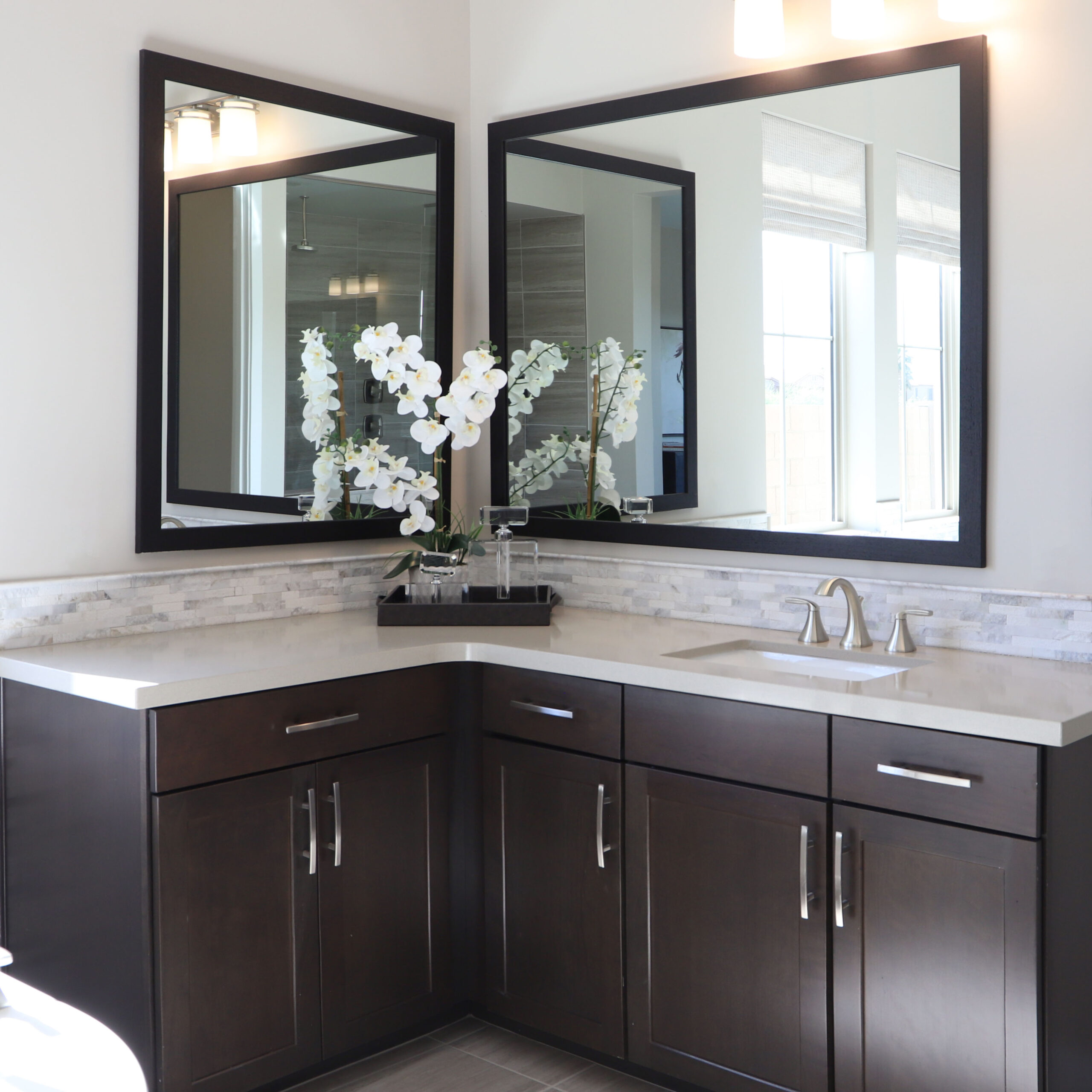 photo of a scene with two mirrors in a bathroom
