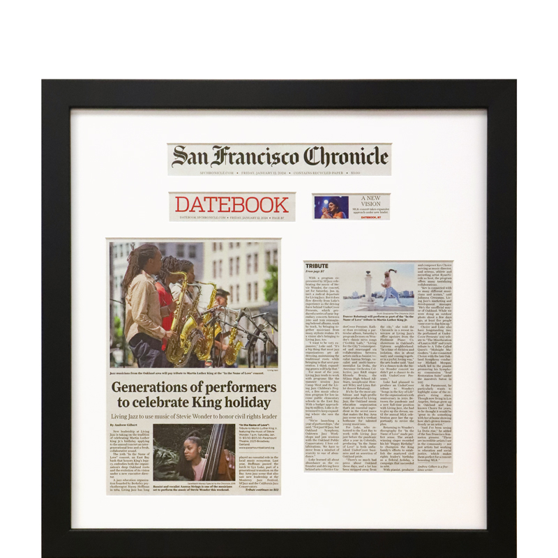 Framed newspaper article with mat cut outs of headlines and stories