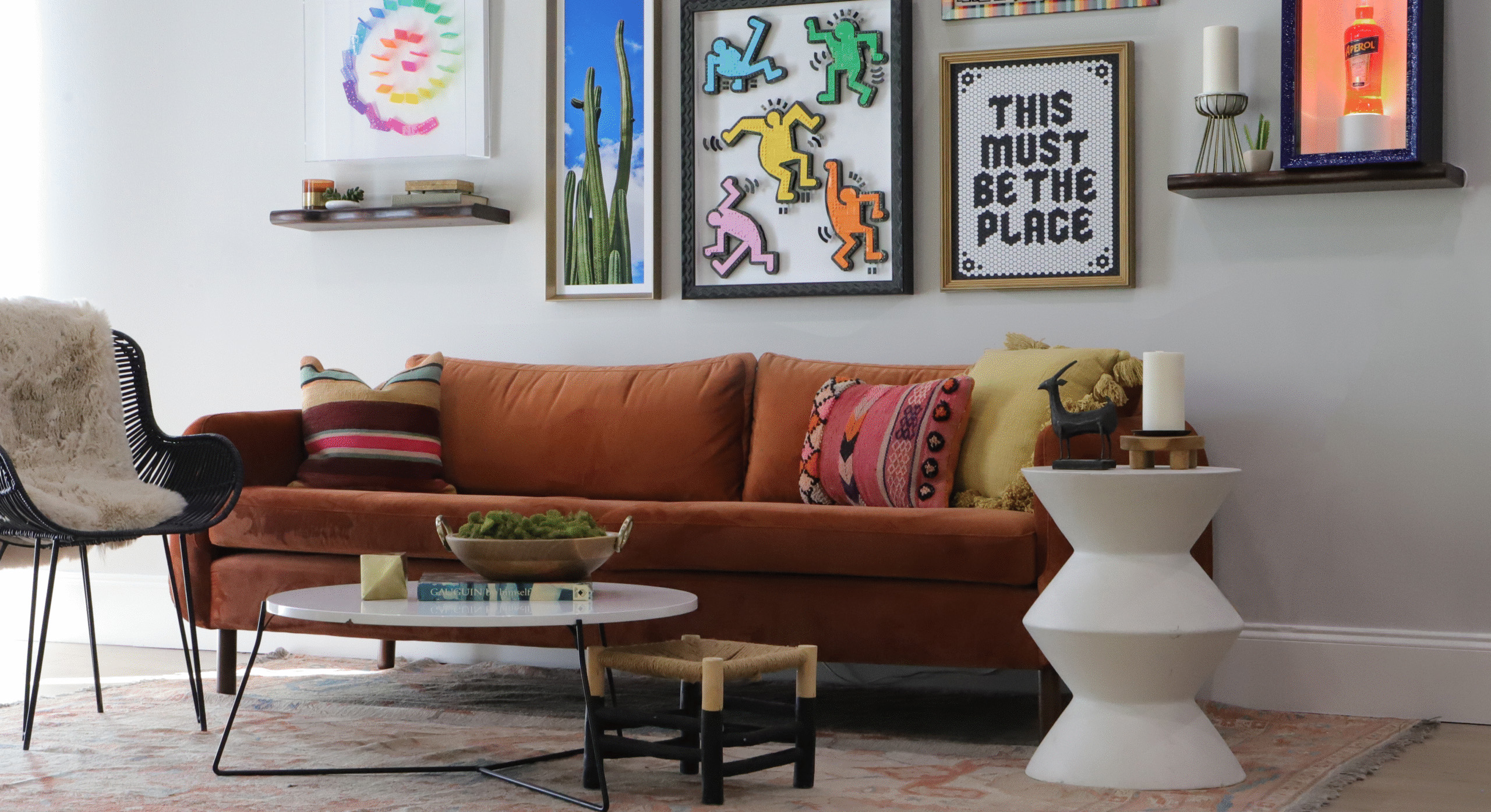 A photo of a midcentury modern living room with a unique gallery wall framed by Hall of Frames 