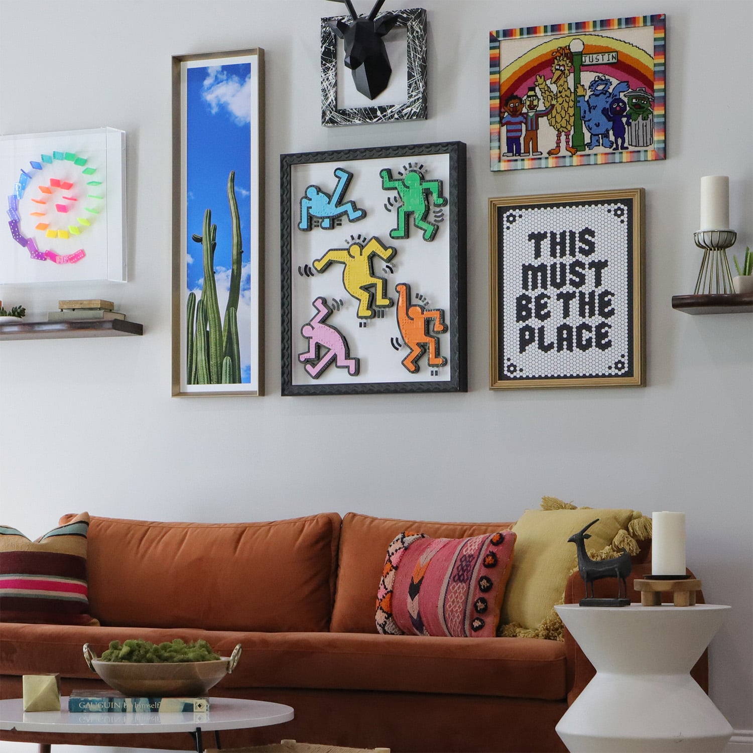 A photo of a midcentury modern living room with a unique gallery wall framed by Hall of Frames 
