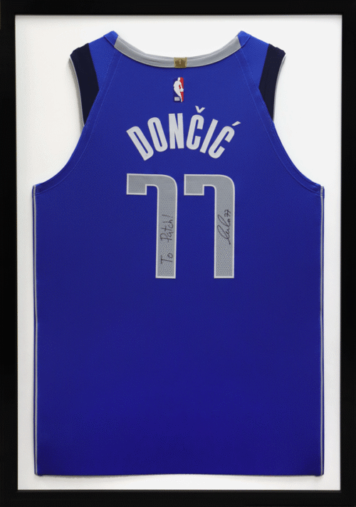 Framed Luka Dončić #77 Dallas Mavericks blue jersey, silver numbers, with a signed inscription.
