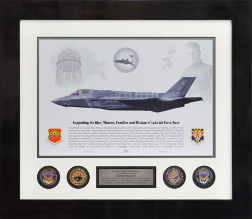 Framed Luke Air Force Base award featuring an F-35 jet, challenge coins, and a dedication plaque.