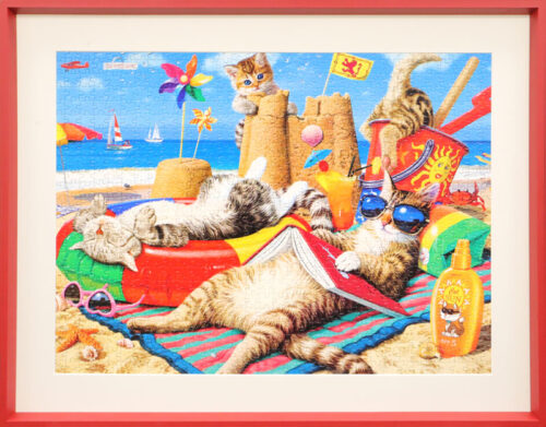 Framed jigsaw puzzle of whimsical cats wearing sunglasses and relaxing on a tropical beach at sunset.