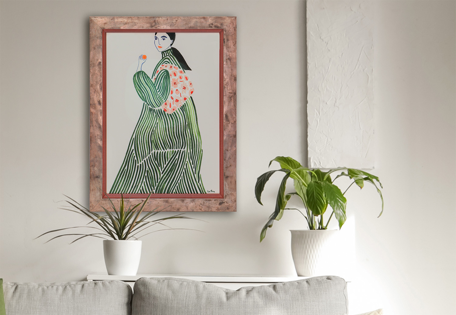 Custom framed wall art with double mat and textured frame above a neutral sofa with plants, modern living room decor.